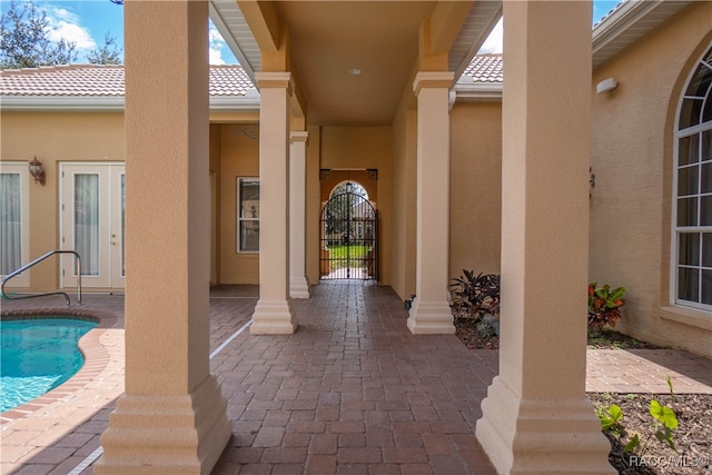 view of exterior entry featuring a patio area