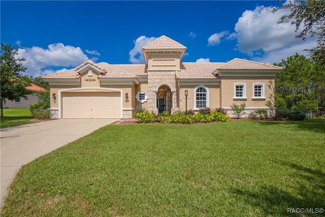 mediterranean / spanish home featuring a garage and a front yard