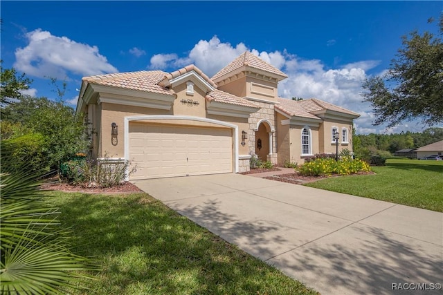 mediterranean / spanish-style house featuring a garage and a front yard