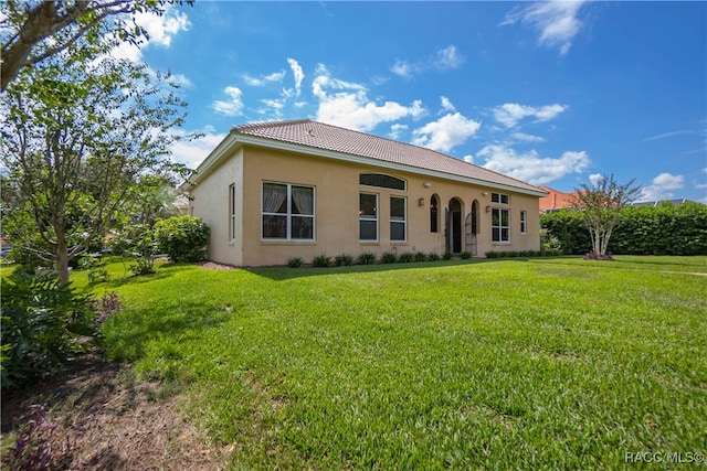 rear view of house with a yard