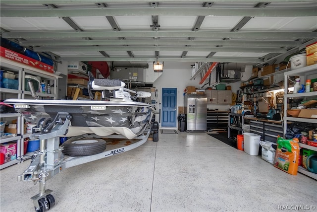 garage with stainless steel refrigerator with ice dispenser