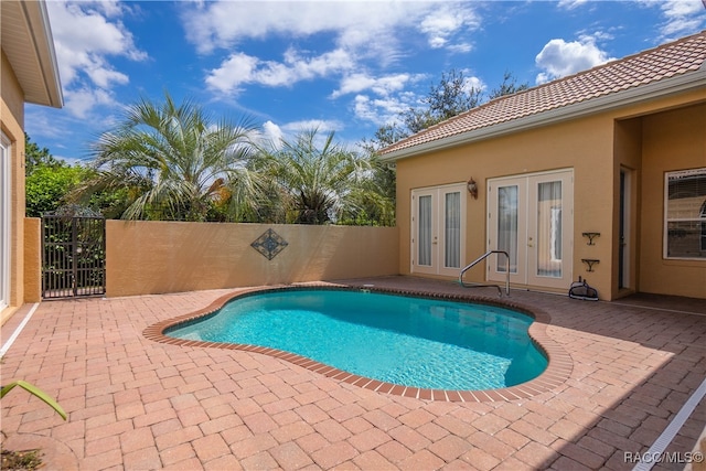 view of pool with french doors and a patio area