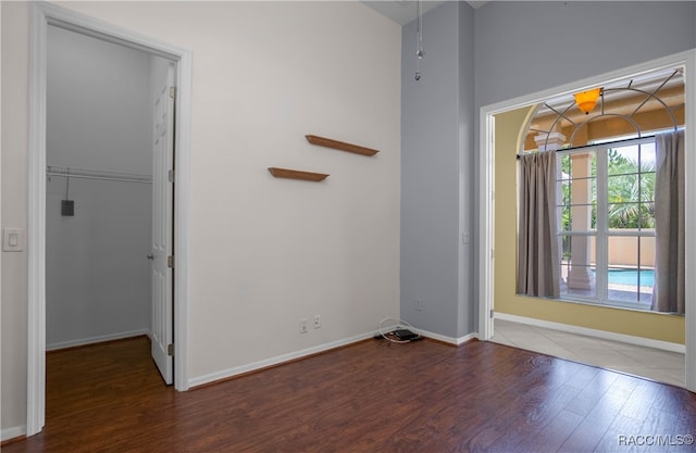 unfurnished room with dark hardwood / wood-style floors