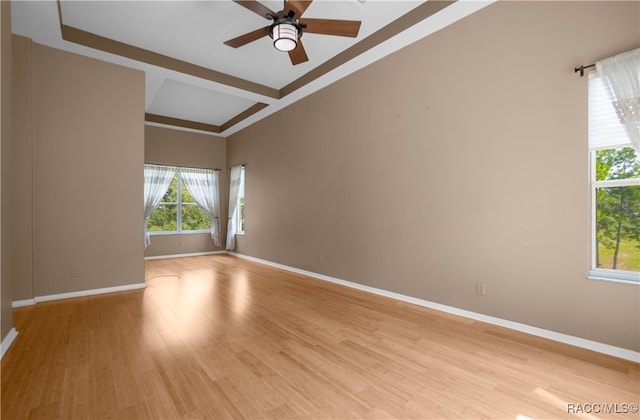 empty room with ceiling fan and light wood-type flooring