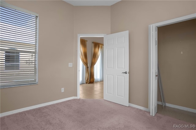 empty room featuring plenty of natural light and light carpet