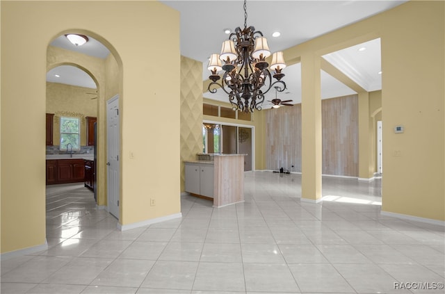 unfurnished dining area featuring light tile patterned floors and ceiling fan with notable chandelier