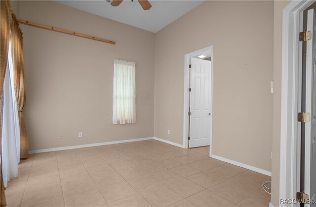 unfurnished room featuring light tile patterned floors and ceiling fan