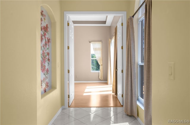 corridor featuring light tile patterned floors