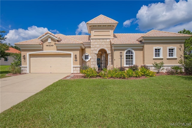 mediterranean / spanish-style home featuring a front yard and a garage