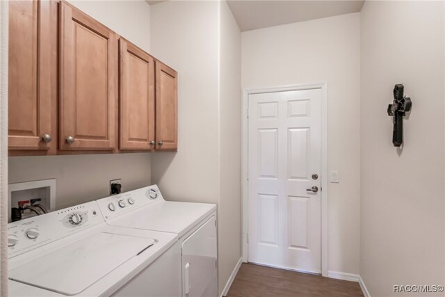 1052 W Diamond Shore Loop, Hernando, FL 34442 - clothes washing area with cabinet space, washing machine and dryer, baseboards, and dark wood-type flooring