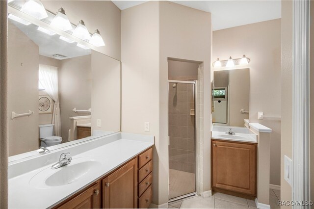1052 W Diamond Shore Loop, Hernando, FL 34442 - bathroom with a stall shower, two vanities, toilet, and tile patterned floors