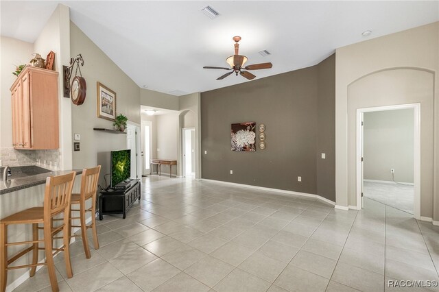 1052 W Diamond Shore Loop, Hernando, FL 34442 - living area featuring light tile patterned floors, ceiling fan, arched walkways, and baseboards