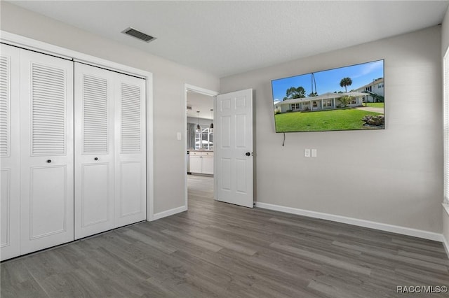 1930 NW 17th St, Crystal River, FL 34428 - kitchen featuring appliances with stainless steel finishes, light stone countertops, a peninsula, and wood finished floors