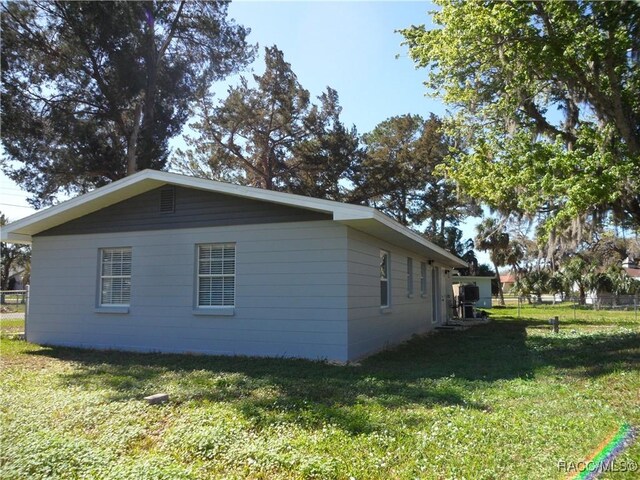 view of side of home with a lawn