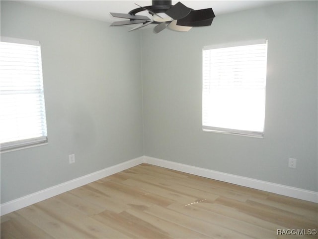 empty room with light wood-type flooring, baseboards, and a ceiling fan