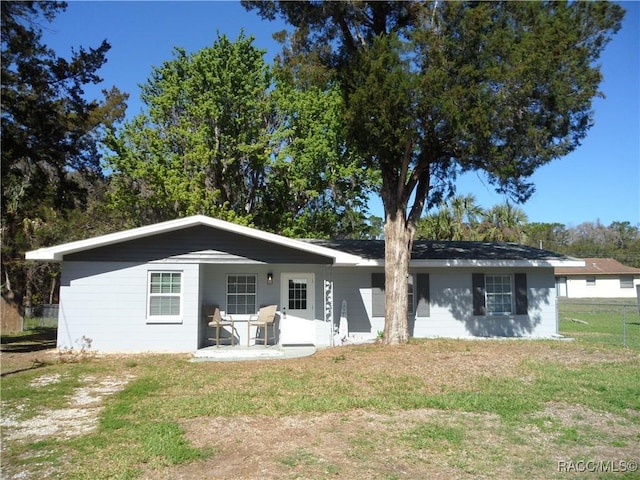 rear view of property with a patio and a yard