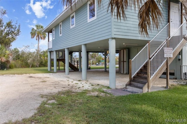 5500 S Cedar Mill Path, Homosassa, FL 34448 - view of home's exterior featuring stairway, a carport, and a lawn