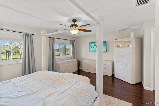 5500 S Cedar Mill Path, Homosassa, FL 34448 - bedroom with a textured ceiling, dark wood-style floors, and a ceiling fan