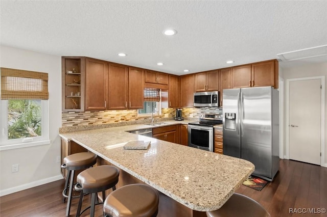 5500 S Cedar Mill Path, Homosassa, FL 34448 - kitchen featuring appliances with stainless steel finishes, open shelves, brown cabinetry, decorative backsplash, and a textured ceiling