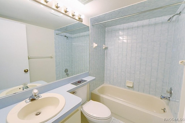 full bathroom with tiled shower / bath combo, vanity, and toilet