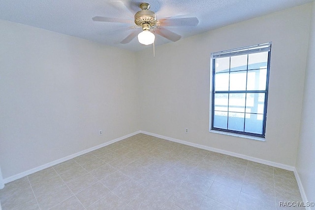 empty room featuring a textured ceiling and ceiling fan