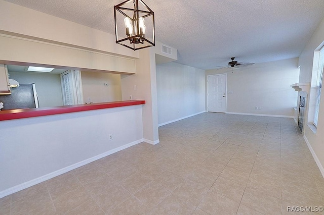 interior space featuring a textured ceiling and ceiling fan