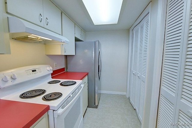 kitchen with white cabinetry, light tile patterned flooring, and electric stove