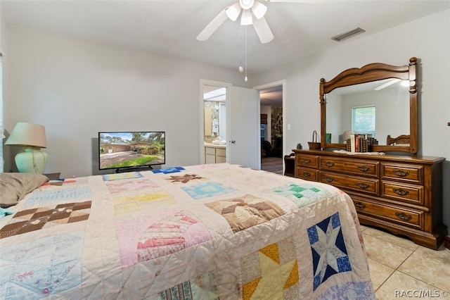 bedroom with ensuite bath, ceiling fan, and light tile patterned flooring