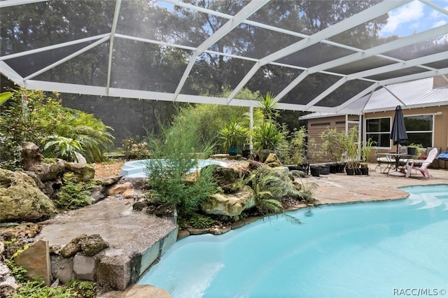 view of pool with a patio and glass enclosure