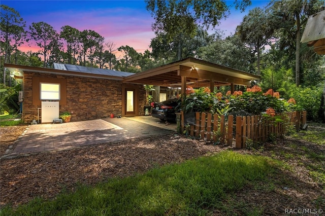 exterior space featuring solar panels and a carport