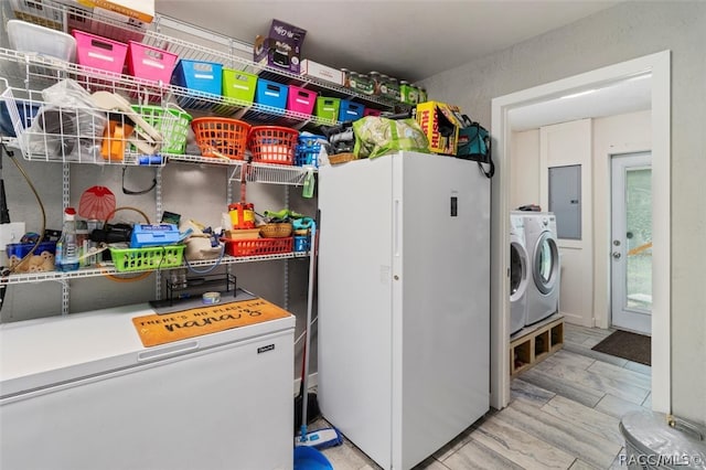 laundry room with electric panel and washing machine and clothes dryer