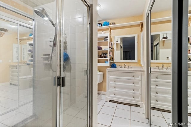 bathroom featuring tile patterned floors, vanity, and a shower with shower door