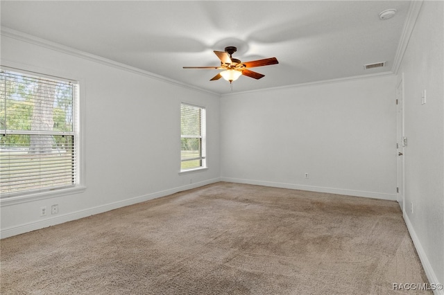 carpeted empty room with ceiling fan and crown molding