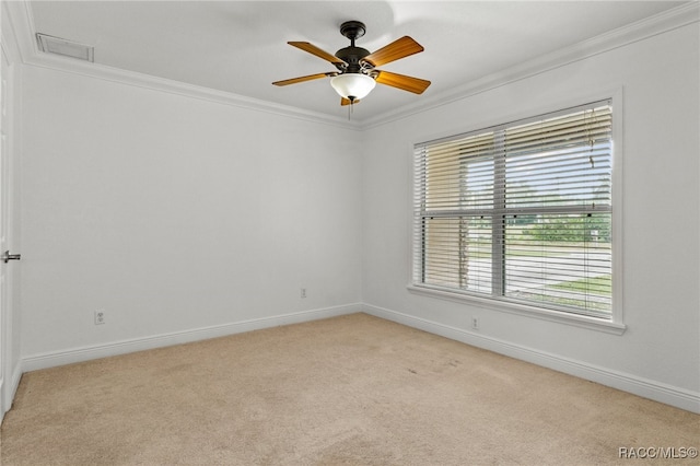 carpeted spare room with ceiling fan and ornamental molding