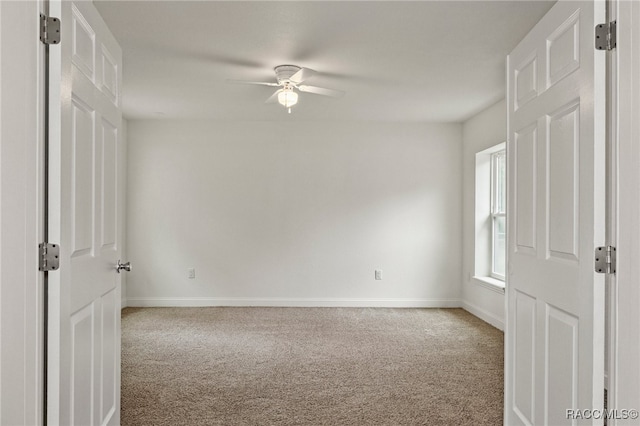 carpeted empty room with ceiling fan