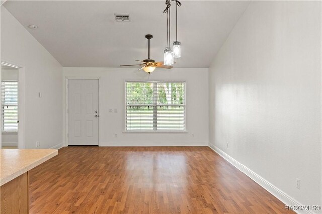 unfurnished living room featuring ceiling fan, light wood-type flooring, and lofted ceiling