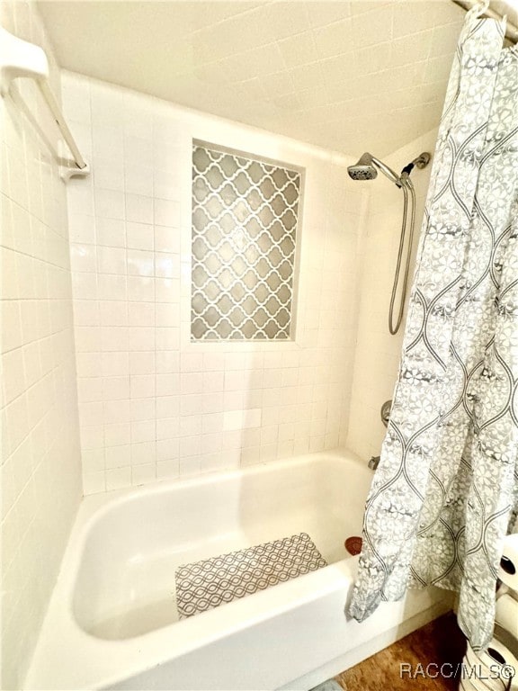 bathroom with shower / bath combination with curtain