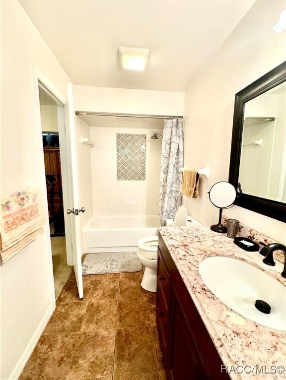 full bath featuring toilet, shower / bath combination with curtain, and vanity