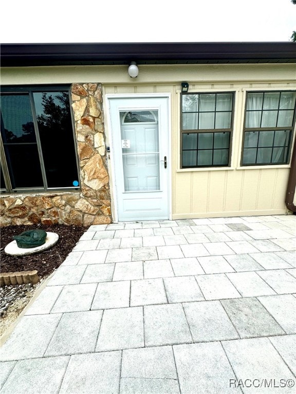 view of exterior entry featuring stone siding