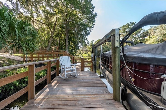 wooden terrace featuring a hot tub