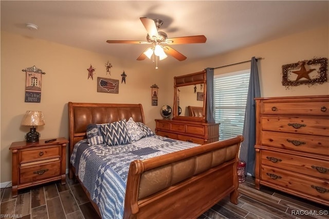 bedroom with ceiling fan and dark wood-type flooring