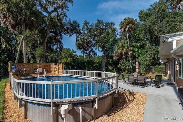 view of swimming pool featuring a patio area