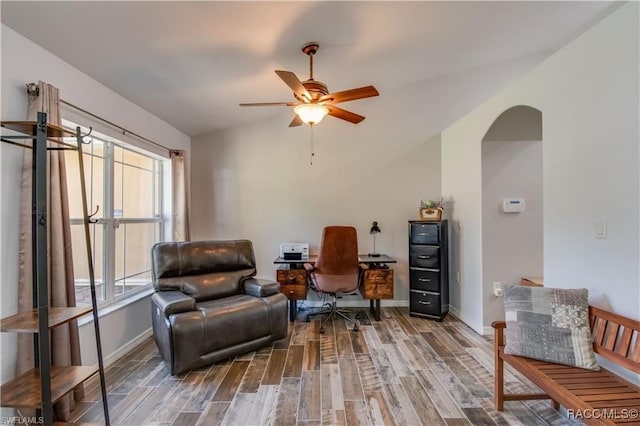 living area with ceiling fan, wood-type flooring, and vaulted ceiling