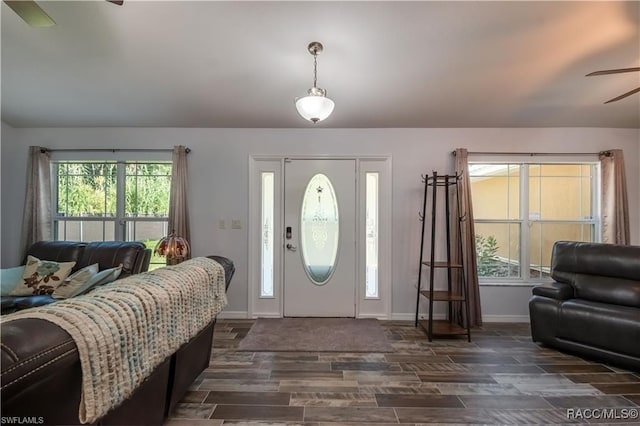 foyer entrance with ceiling fan and dark hardwood / wood-style flooring