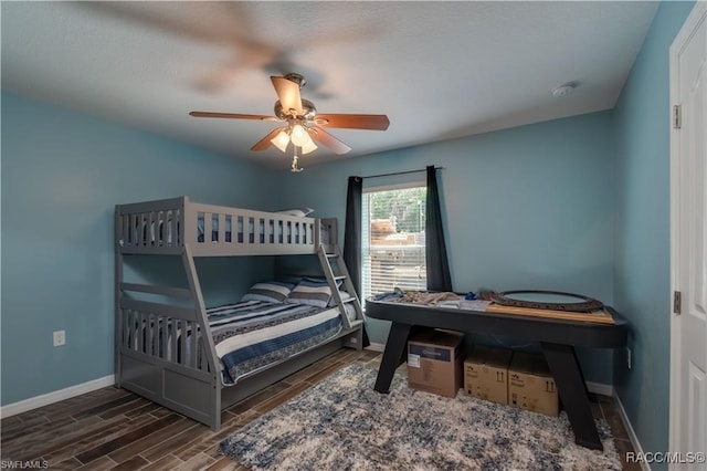 bedroom with dark hardwood / wood-style flooring and ceiling fan