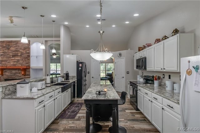 kitchen with a healthy amount of sunlight, sink, white cabinets, and black appliances