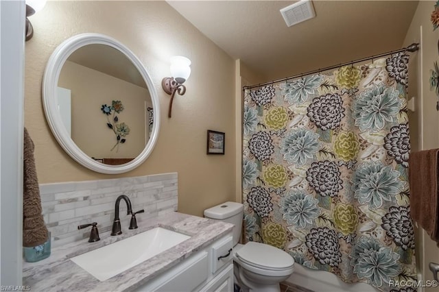 bathroom featuring decorative backsplash, vanity, and toilet