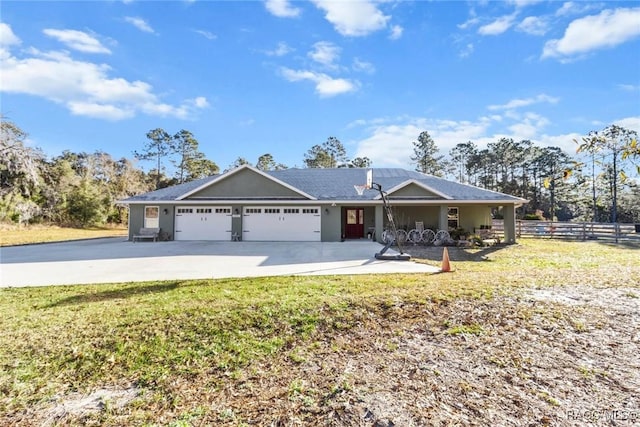 ranch-style house featuring a garage and a front lawn