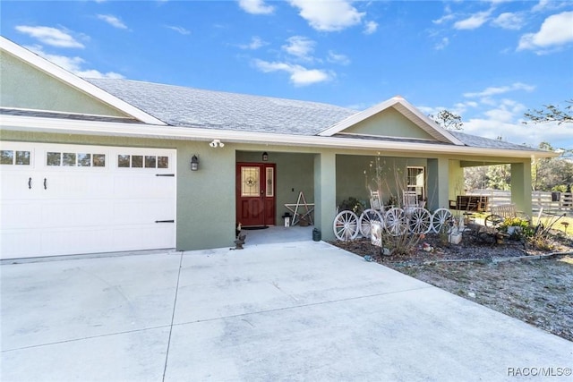 ranch-style home with a garage and covered porch