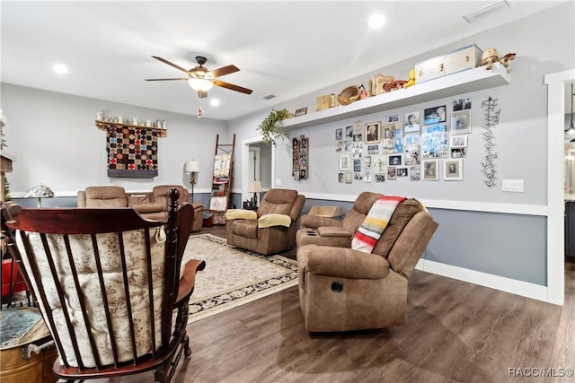 living room with ceiling fan and dark hardwood / wood-style flooring